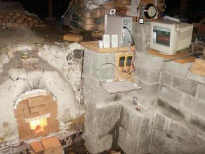 wood burning in the kiln early in the firing