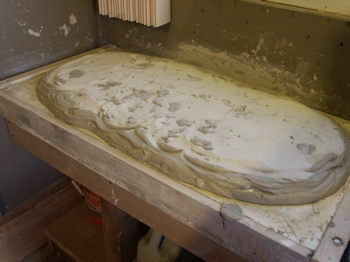 Pouring out freshly mixed clay on the wedging table